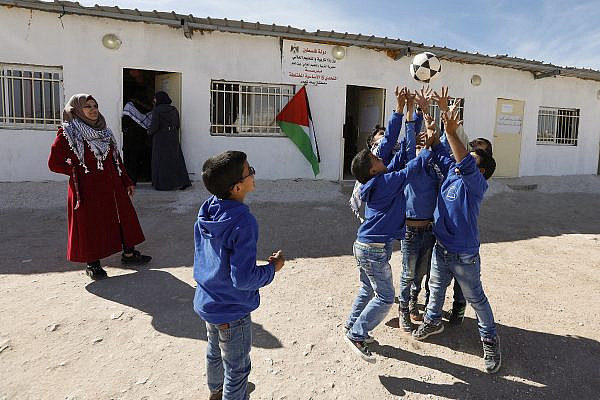 Palestinian school children play in front of their school which faces the threat of demolition, in the village of Jubbet ad-Dib near Bethlehem in the occupied West Bank, November 18, 2018. (Wisam Hashlamoun/Flash90)