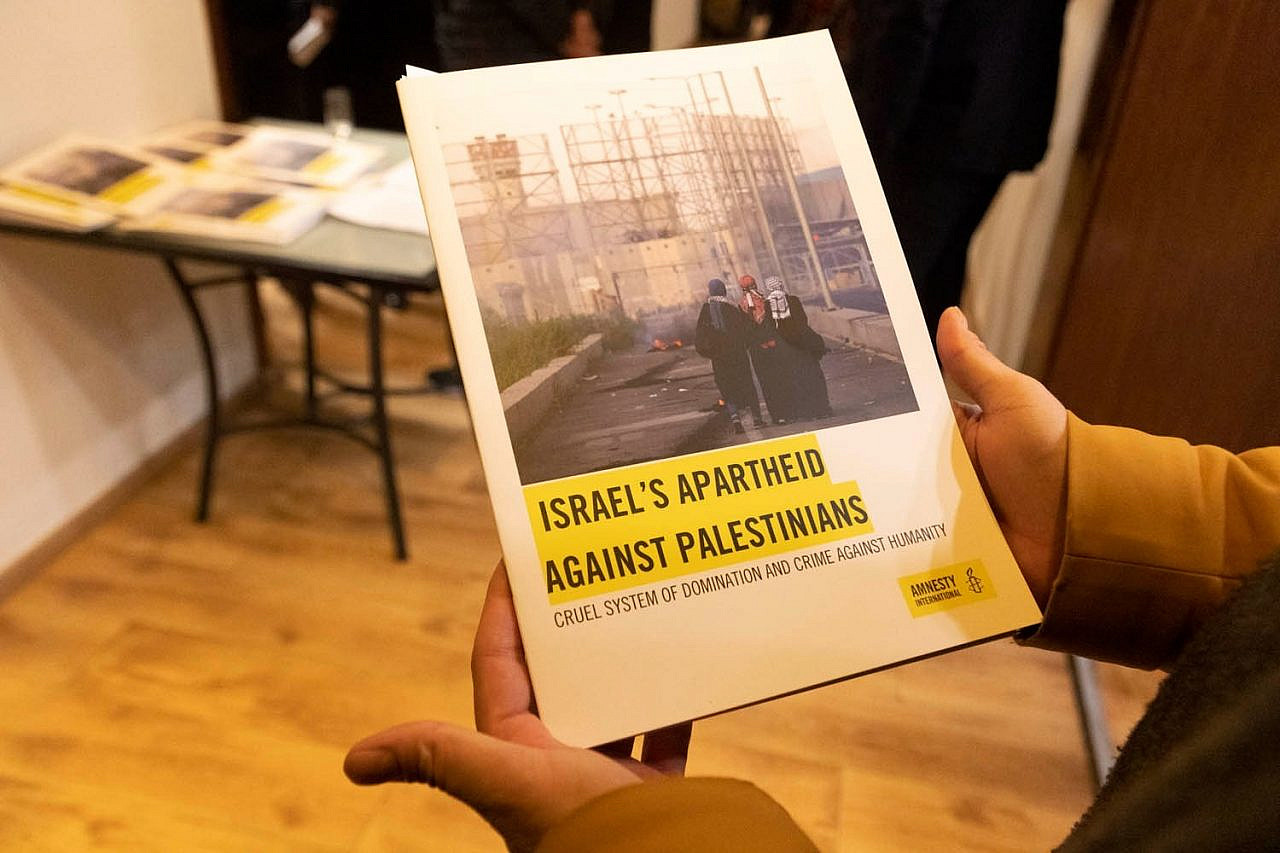 A copy of Amnesty International's new report accusing Israel of committing the crime of apartheid against Palestinians, launched in Jerusalem on February 1, 2022. (Oren Ziv)