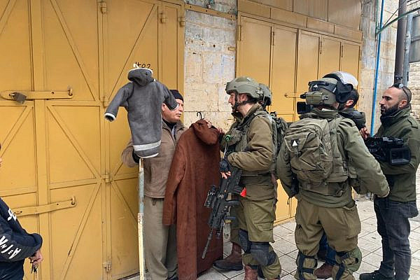 Israeli soldiers are seen enforcing the closure of Palestinian-owned stores in Hebron's Old City, occupied West Bank, Jan. 29, 2022. (Basil al-Adraa)