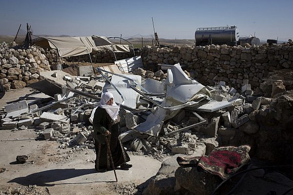 A Palestinian woman next to demolished home after they were torn down by Israeli bulldozers in the village of Khirbet al-Halawah, in Firing Zone 918, South Hebron, Hills, West Bank, February 3, 2016. (Oren Ziv/Activestills)