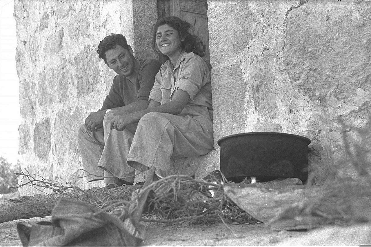 Palmach soldiers sit in the entrance of a building in the depopulated Palestinian village of Bayt Nattif, near Jerusalem, October 1948. (GPO)