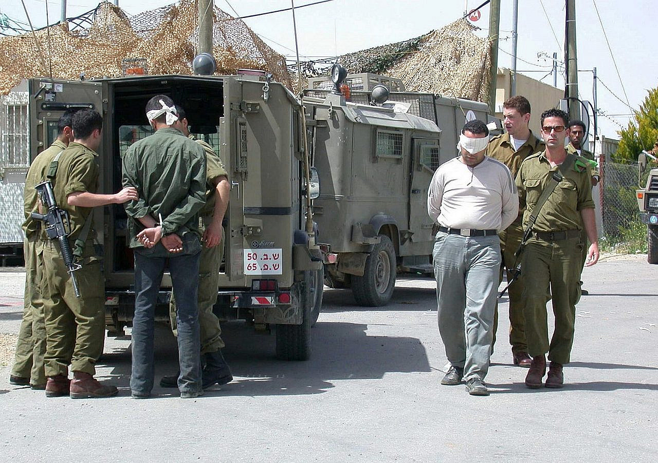 Israeli soldiers detain Palestinians in Jenin during "Operation Defensive Shield" in the Second Intifada, April, 2002. (GPO)