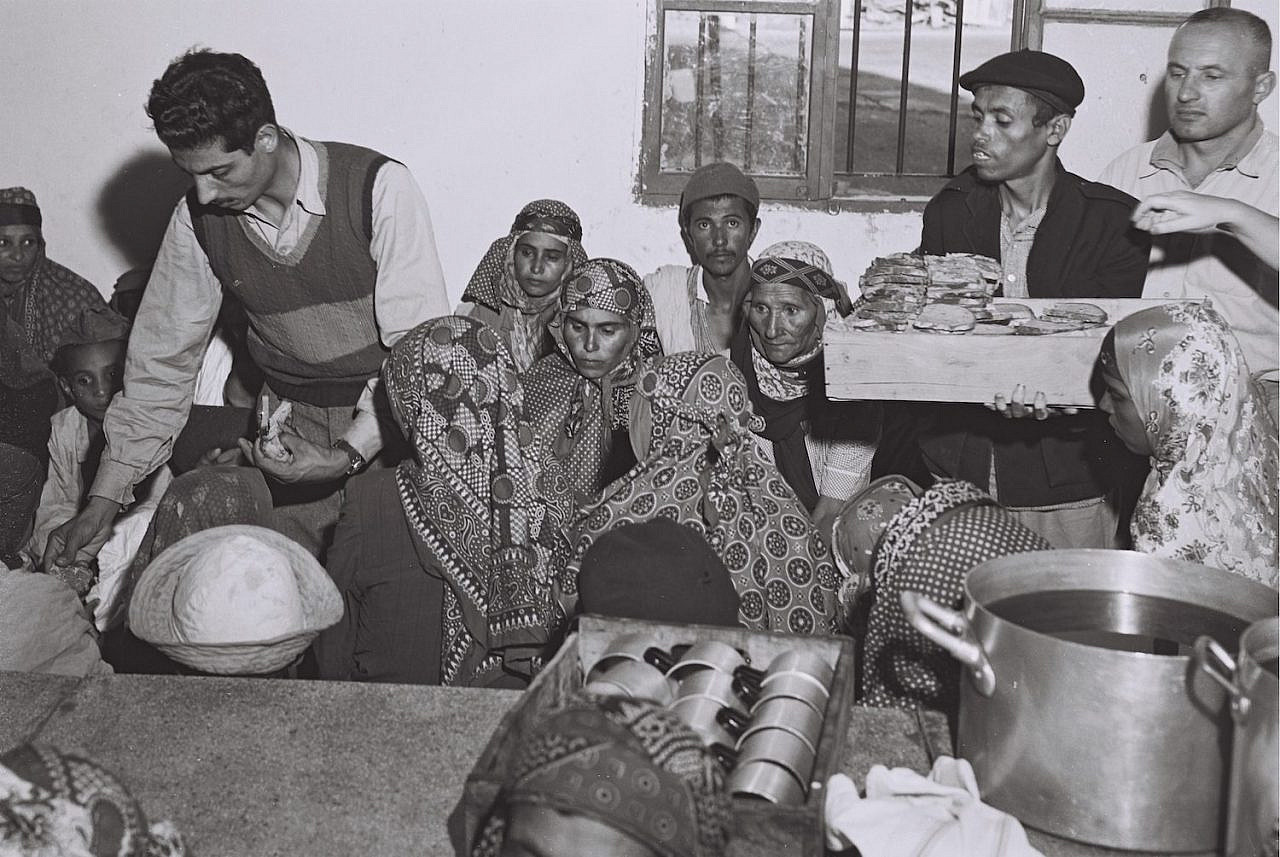 Yemenite immigrants eat their first meal after being airlifted from Yemen and landing in Israel, October 23, 1949. (Teddy Brauner/GPO)