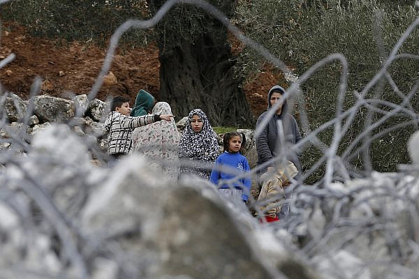 Palestinians inspect the ruins of a Palestinian house that was demolished by Israeli bulldozers in the West Bank city of Beit Jala, near Bethlehem, on January 29, 2018. (Wisam Hashlamoun/Flash90)