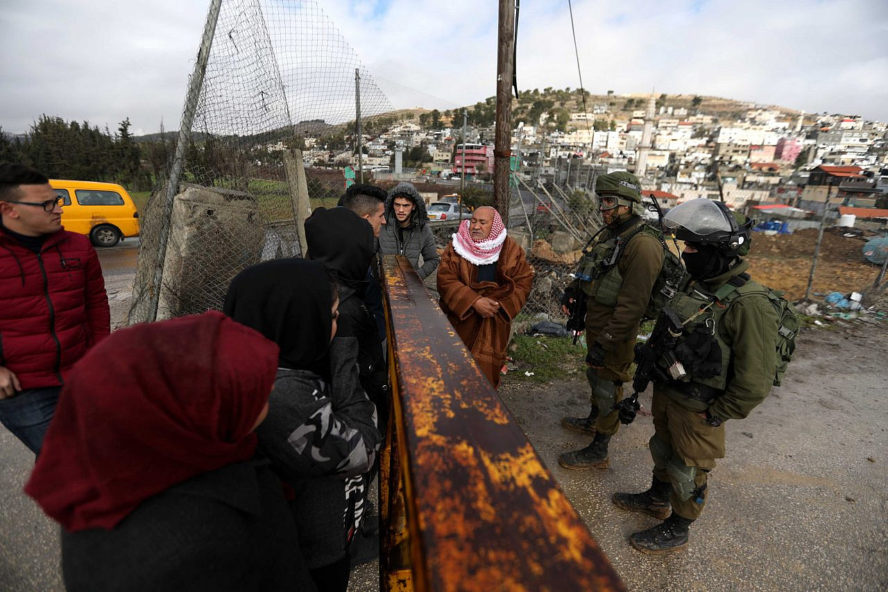 Israeli soldiers block the entrance to Al-Arroub refugee camp, north of Hebron, February 10, 2020. (Wisam Hashlamoun/Flash90)
