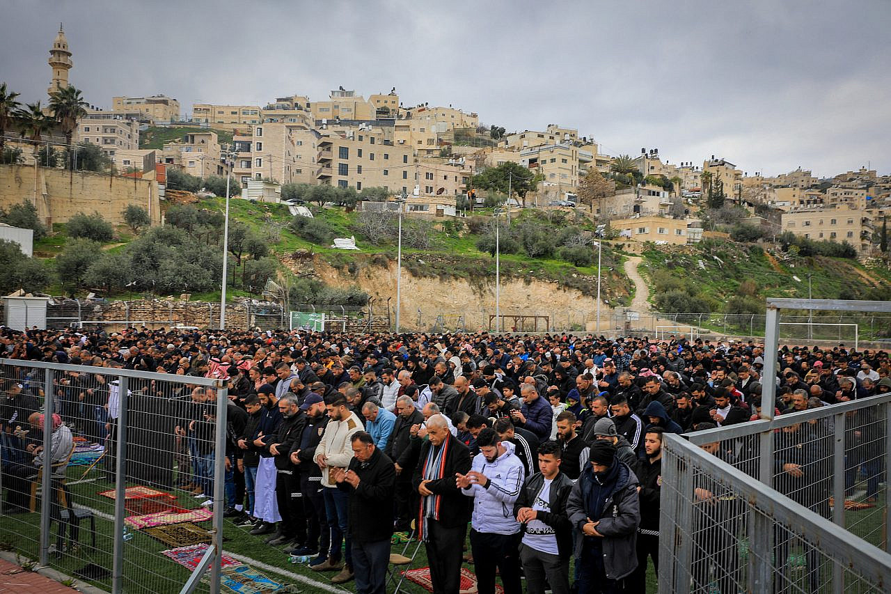 Palestinians perform Friday prayers as they protest against the demolition of houses by the Jerusalem municipality, Jabel Mukaber, Jerusalem, March 4, 2022. (Jamal Awad/Flash90)