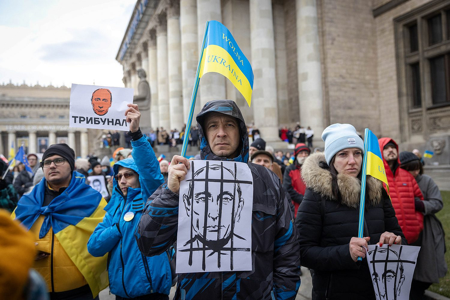 Demonstrators and Ukrainian refugees carry placards and flags during a protest against the Russian invasion of Ukraine, outside the Palace of Culture and Science in Warsaw, Poland, March 6, 2022. (Olivier Fitoussi/Flash90)