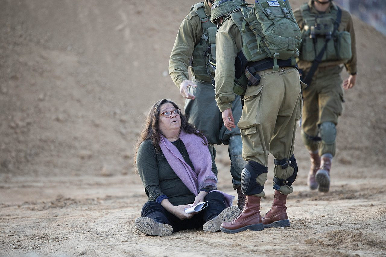 Neta Golan is apprehended by Israeli soldiers during a protest by Israeli activists against the siege on Gaza, at the Israeli side of the fence, December 2018. (Oren Ziv)