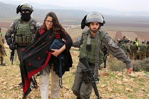 Neta Golan being arrested by Israeli forces during a protest in Turmus Ayya, occupied West Bank, December 19, 2014. (Courtesy of Neta Golan)