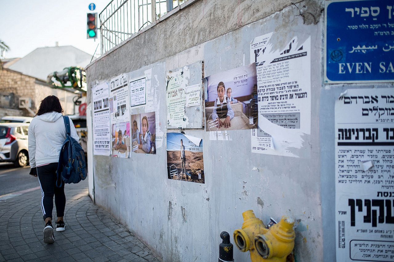 Posters bearing the faces of Palestinian residents of Masafer Yatta are seen on a Jerusalem street after having been plastered around the city by activists in the #SaveMasaferYatta campaign. (Emily Glick)