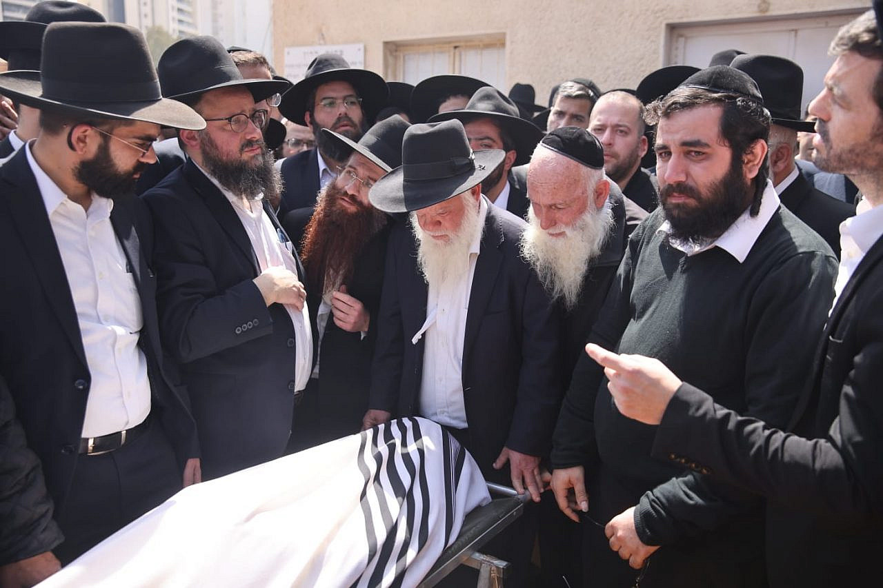 Haredi mourners bury one of the victims of the attack in the city of Bnei Brak by a Palestinian gunman, March 30, 2022. (Oren Ziv) 