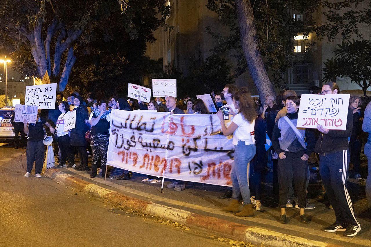 Palestinian single mothers from Jaffa protest alongside activists from Shovrot Kirot outside the home of Justice Minister Gideon Sa'ar, holding a banner that reads "Women of Jaffa demand housing", November 27, 2021. (Oren Ziv)