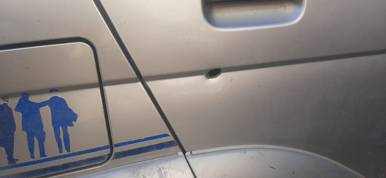 A bullet entry mark in the door of Ahmad Ghunaimat's car, in which his two young children were sitting, Surif, occupied West Bank, April 23, 2022. (Courtesy)