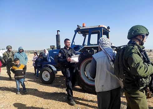 Israeli soldiers confiscate a Palestinian-owned tractor in al-Rakiz, West Bank, December 15, 2021. (Naomi-Nur Tzahor)