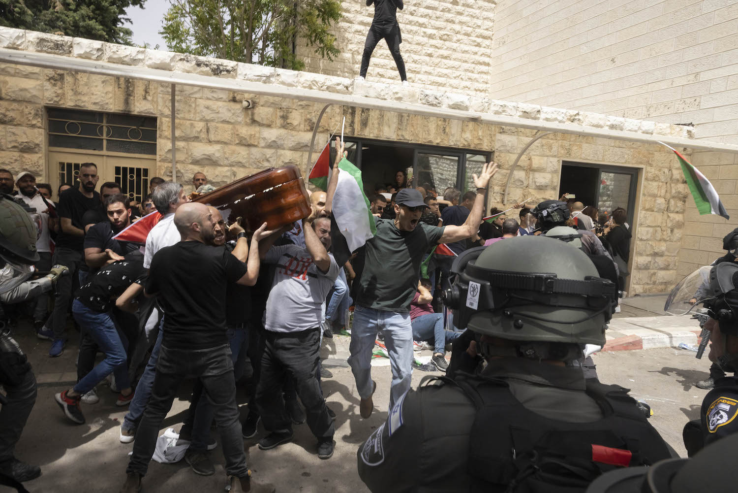 Israeli Border police officers attack Palestinian pallbearers carrying the coffin of slain journalist Shireen Abu Akleh, Jerusalem, May 13, 2022. (Oren Ziv)