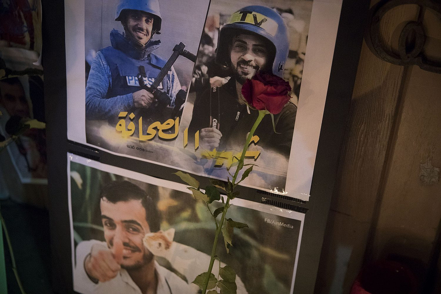 Photos of Palestinian journalists killed by Israeli forces during the #GreatReturnMarch protests in Gaza, are shown during a vigil held by Palestinian citizens of Israel and Israeli activists in solidarity with the people in Gaza, Jaffa, April 27, 2018. (Oren Ziv/Activestills)