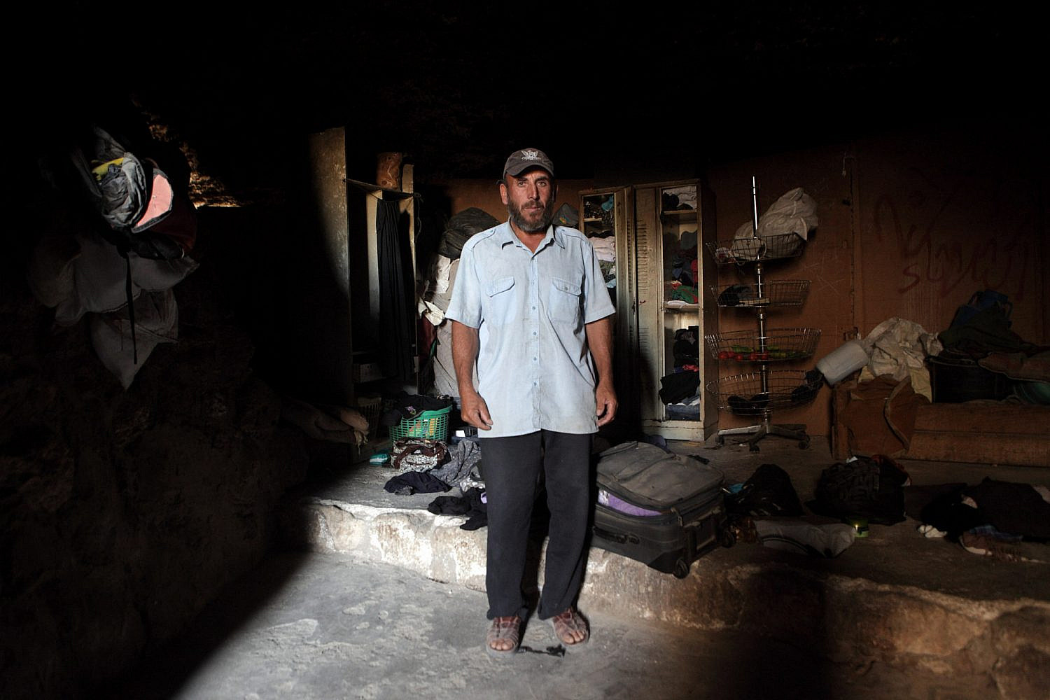 Mohammad Youssef Abu Arham, father of four children, stands in his residential cave inside the West Bank village of Jinba, located in the South Hebron Hills, September 6, 2012. (Anne Paq/Activestills)