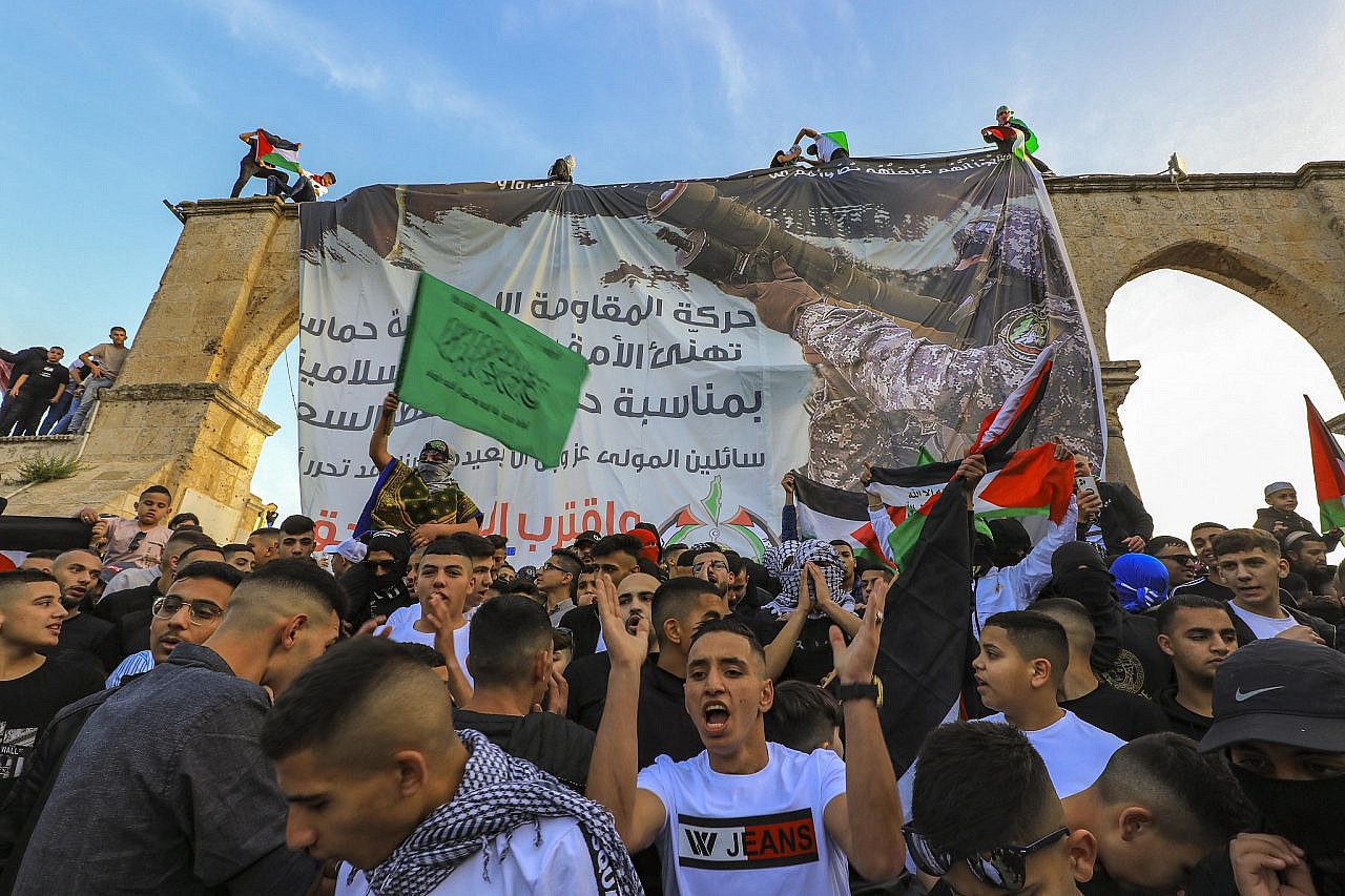 Palestinians raise flags and banners in support of Hamas at the al-Aqsa compound in Jerusalem on Eid al-Fitr, May 2, 2022. (Jamal Awad/Flash90)