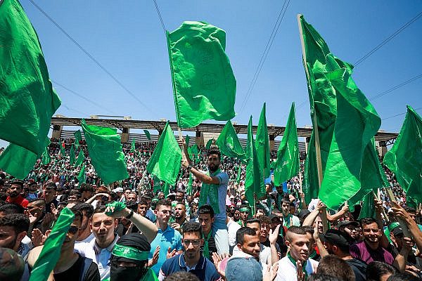 Palestinian student supporters of the Hamas movement wave the movement's flag during a rally at Birzeit University, near the West Bank city of Ramallah, May 19, 2022. (Flash90)
