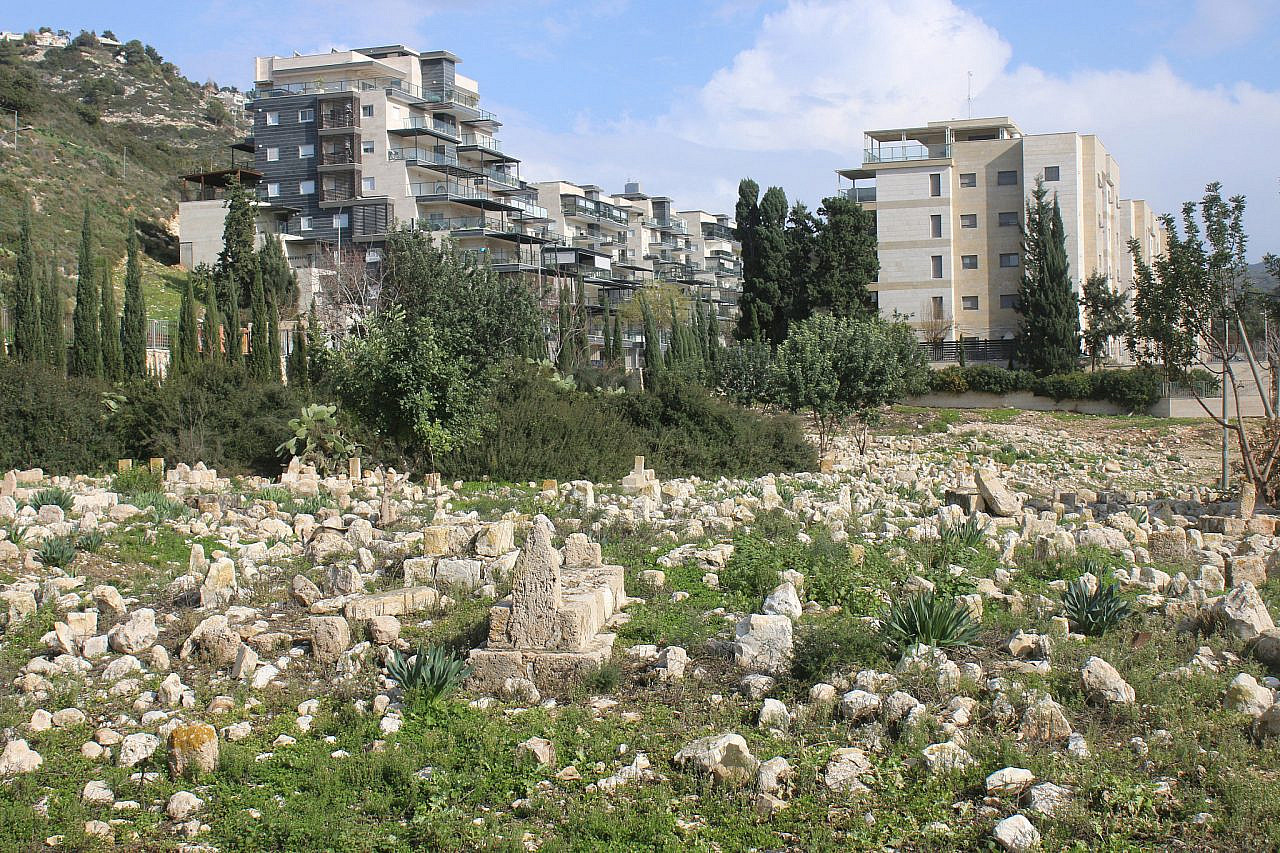 Gli edifici di Tirat HaCarmel si affacciano sul cimitero palestinese del villaggio spopolato di al-Tira, a sud di Haifa.  (Ahmad Al-Bazz)