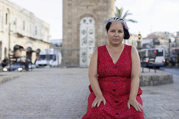 Rachel Beitarie, Executive Director of the left-wing Israeli NGO Zochrot, sits in front of the Jaffa Clock Tower. Around 95% of Jaffa's Palestinian population fled or were expelled during the Nakba. (Oren Ziv)