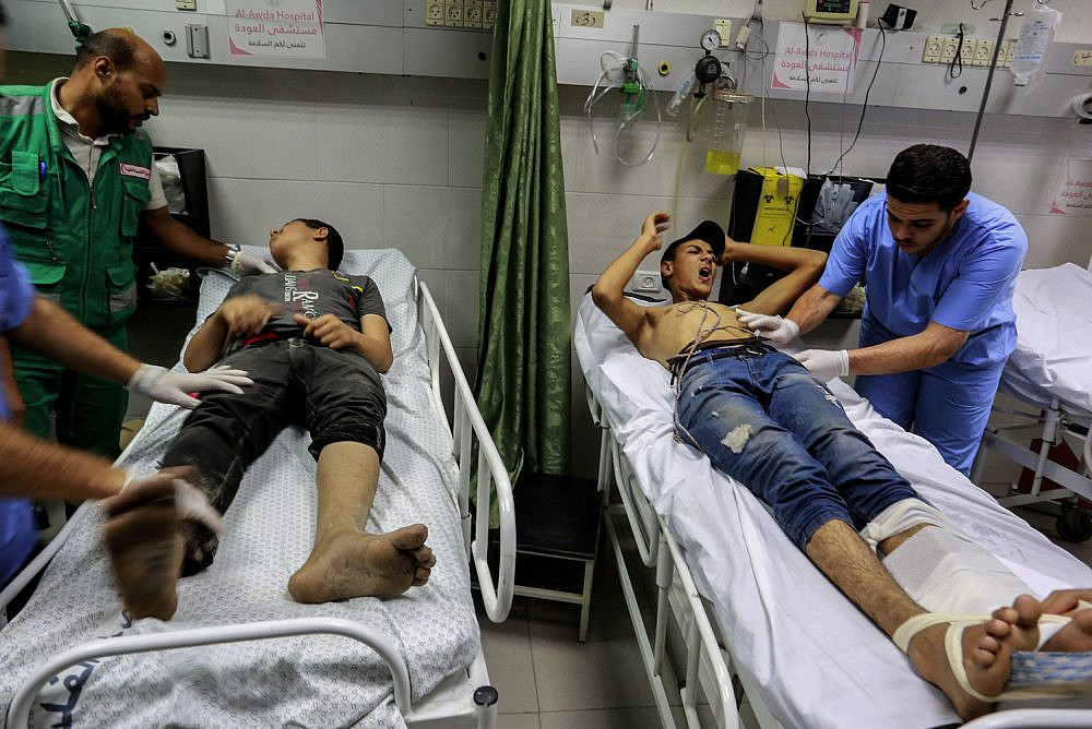 Wounded Palestinian protesters are treated at Al-Awda Hospital after the Israeli navy used live fire and tear gas to block protesters on a 36-vessel flotilla that set out from the northern Gaza Strip, Gaza City, September 24, 2018. (Abed Rahim Khatib/Flash90)