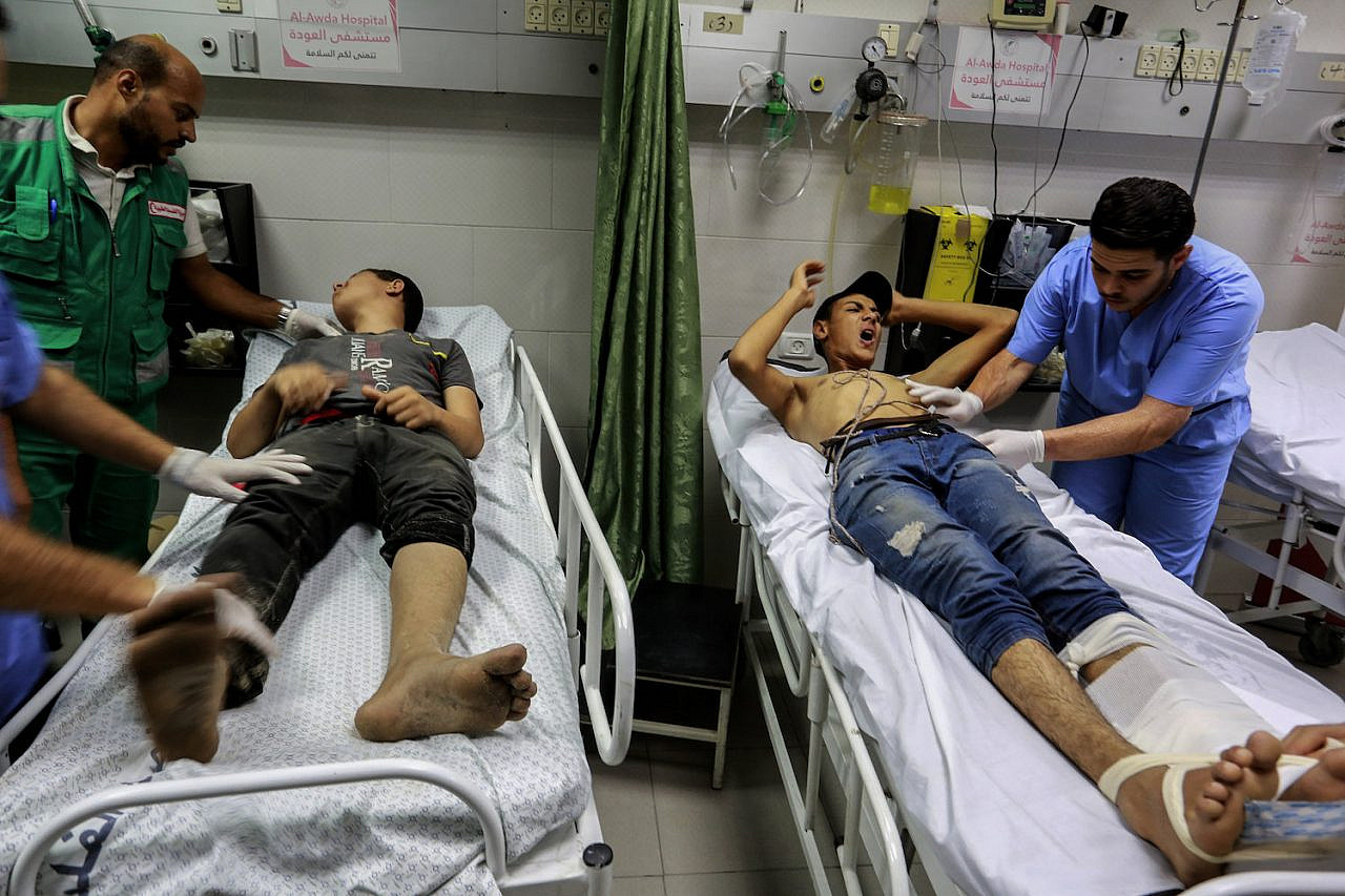 Wounded Palestinian protesters are treated at Al-Awda Hospital after the Israeli navy used live fire and tear gas to block protesters on a 36-vessel flotilla that set out from the northern Gaza Strip, Gaza City, September 24, 2018. (Abed Rahim Khatib/Flash90)