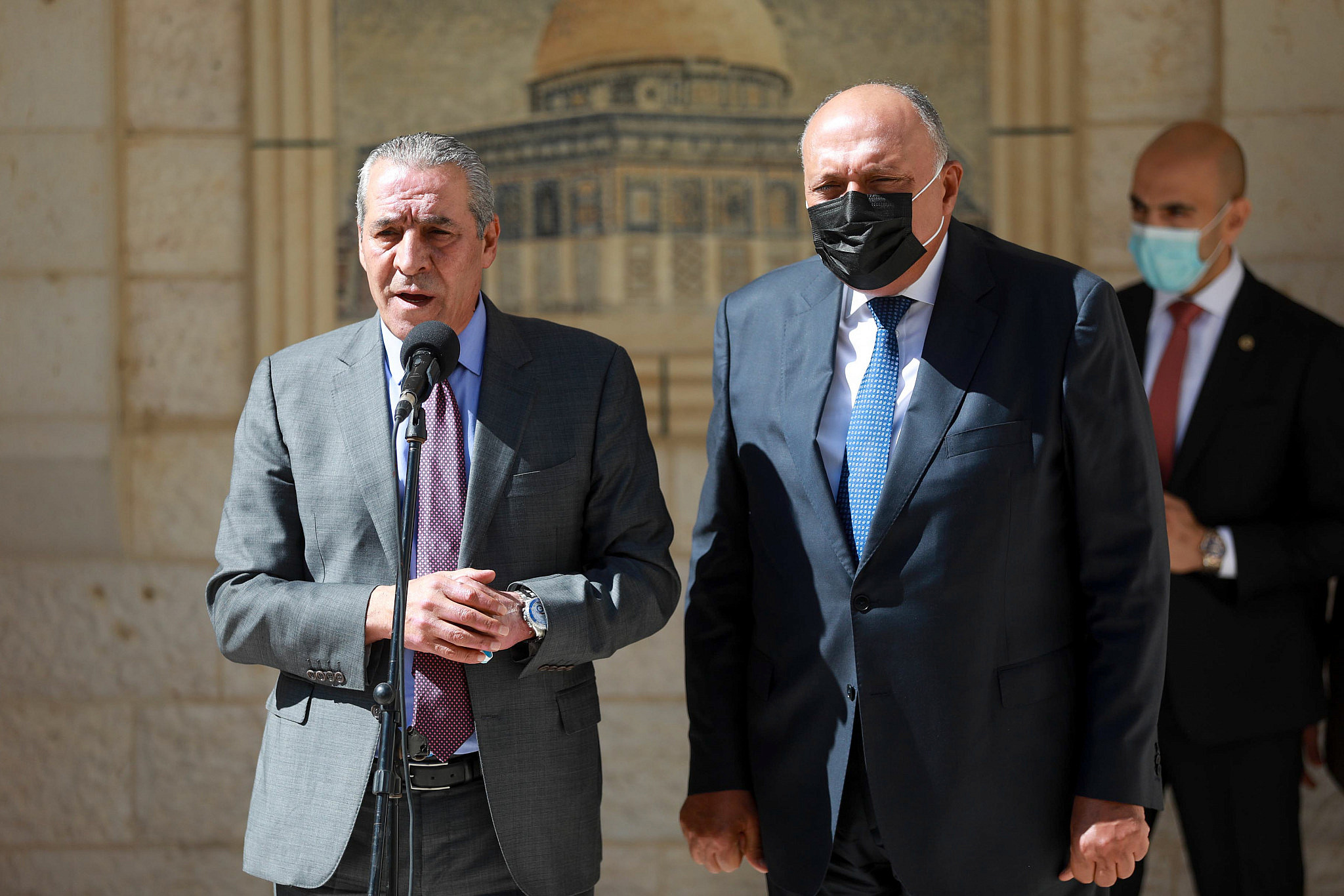 Palestinian Minister Hussein al-Sheikh (left) seen with Egyptian Foreign Minister Sameh Shoukry as he arrives for a meeting in the West Bank city of Ramallah, July 24, 2021. (Flash90)
