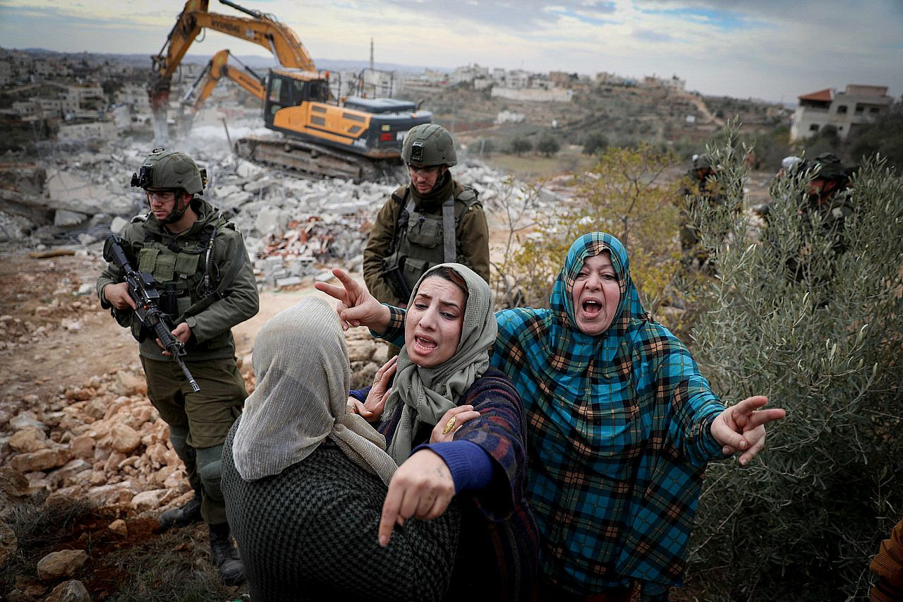 Israeli forces stand guard during the demolition of a Palestinian home, located within "Area C" of the West Bank, near Hebron, December 28, 2021. (Wisam Hashlamoun/Flash90)
