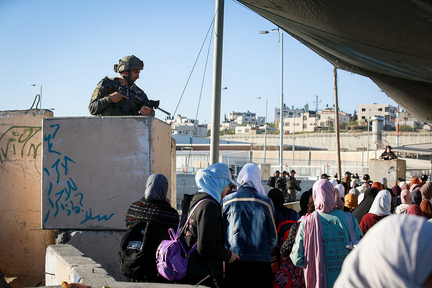 Palestinian Muslim women cross the Qalandiya checkpoint, outside of the West bank city of Ramallah, to attend Friday prayers of the fasting month of Ramadan at Al-Aqsa Mosque compound in Jerusalem, April 15, 2022. (Flash90)