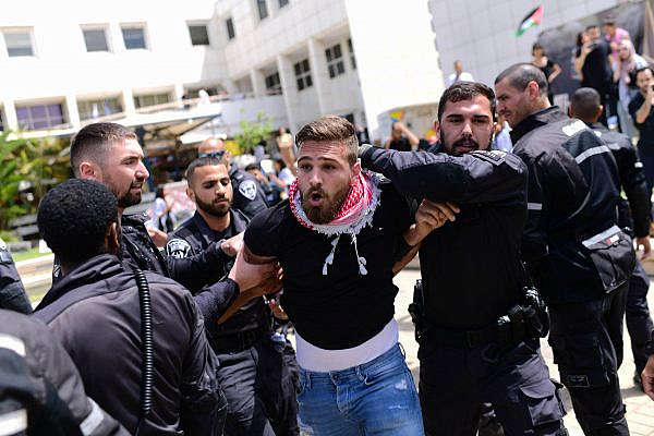 Israeli police officers arrest a Palestinian student ahead of a Nakba Day event at Tel Aviv University, May 15, 2022. (Tomer Neuberg/Flash90)