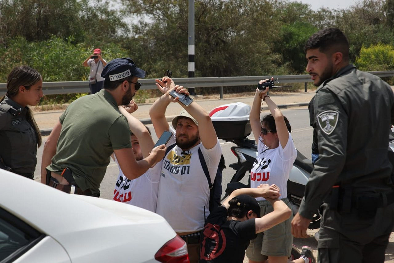Activists from Peace Now block a road to try to prevent a police detention at a demonstration against the Homesh settler outpost, Rosh Ha'ayin, May 28, 2022. (Oren Ziv)