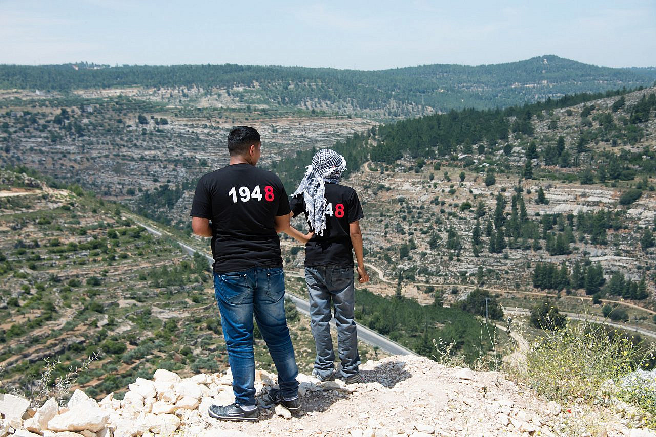 Palestinian youth look over a valley during a Nakba Day protest in the occupied West Bank village of Al-Walaja, May 15, 2014. (Ryan Rodrick Beiler/Activestills)