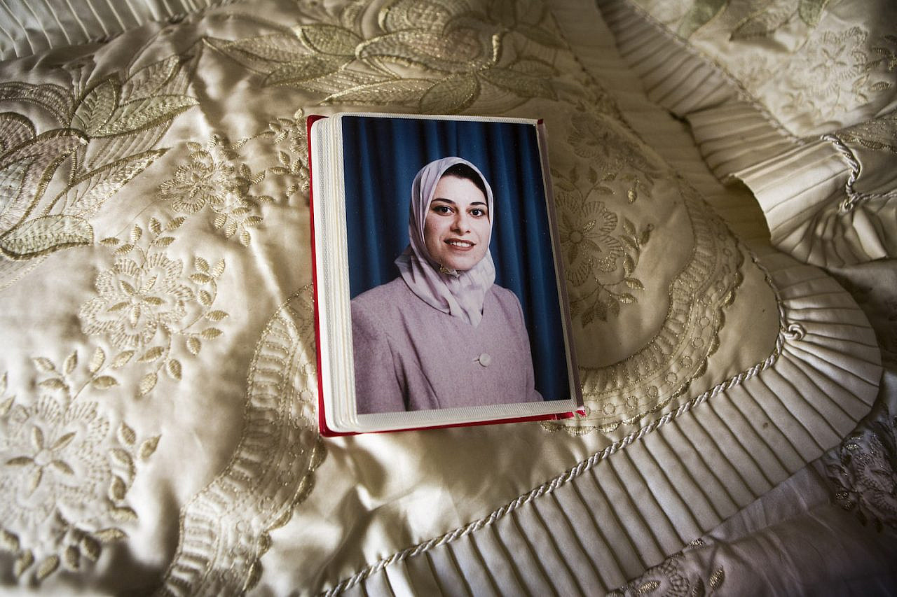 Photo of Taghrid Shabaan al-Kilani set on her bed, in Beit Lahiya, Gaza Strip, September 18, 2014. Taghrid was killed together with her husband Ibrahim and their five children in an Israeli attack on July 21, 2014, when Israeli forces targeted a building in Gaza City. (Anne Paq/Activestills)
