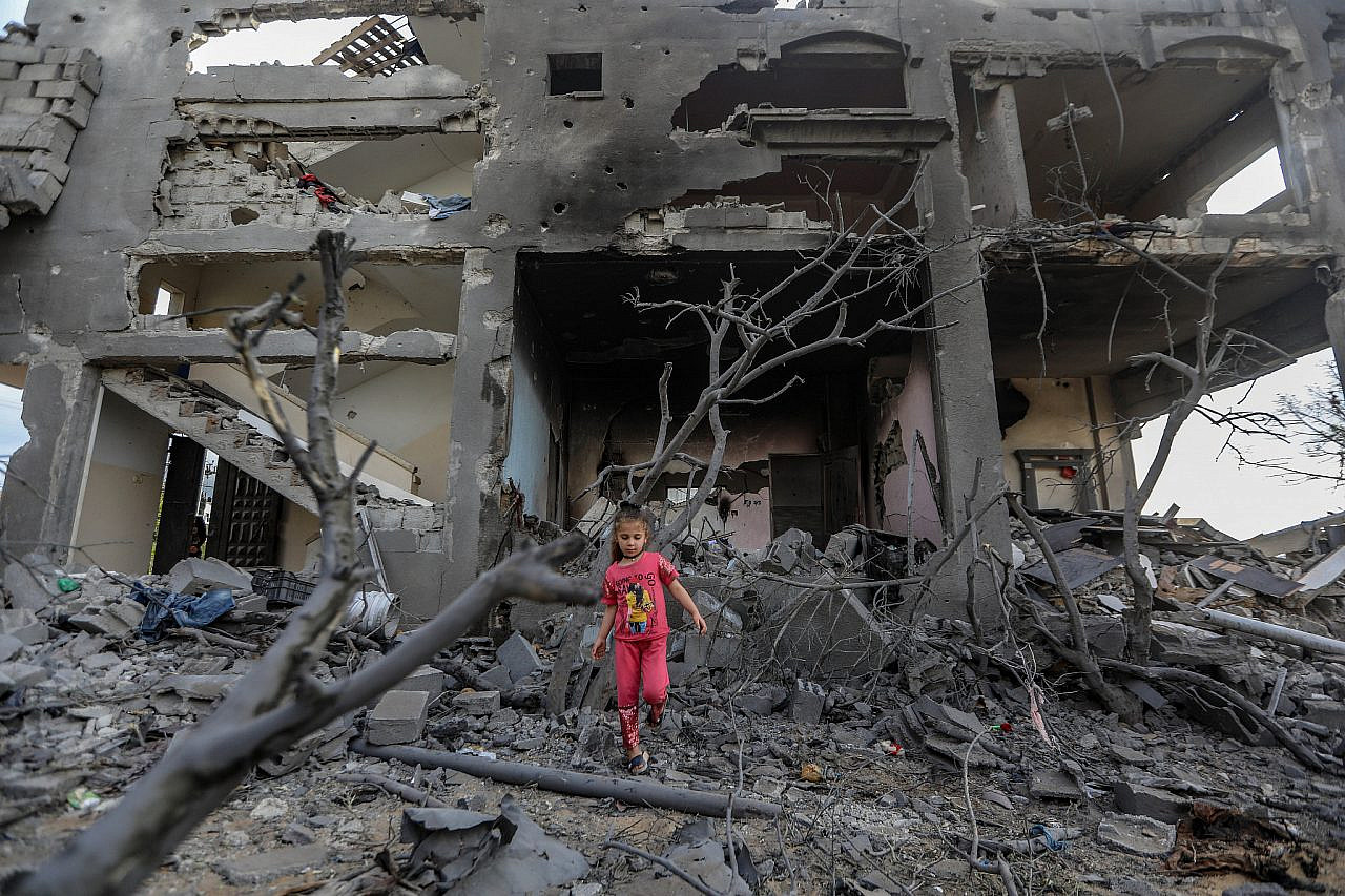 A Palestinian child stands amidst the ruins of a building in the aftermath of Israeli airstrikes, Beit Hanoun, Gaza Strip, May 21, 2021. (Mohammed Zaanoun)
