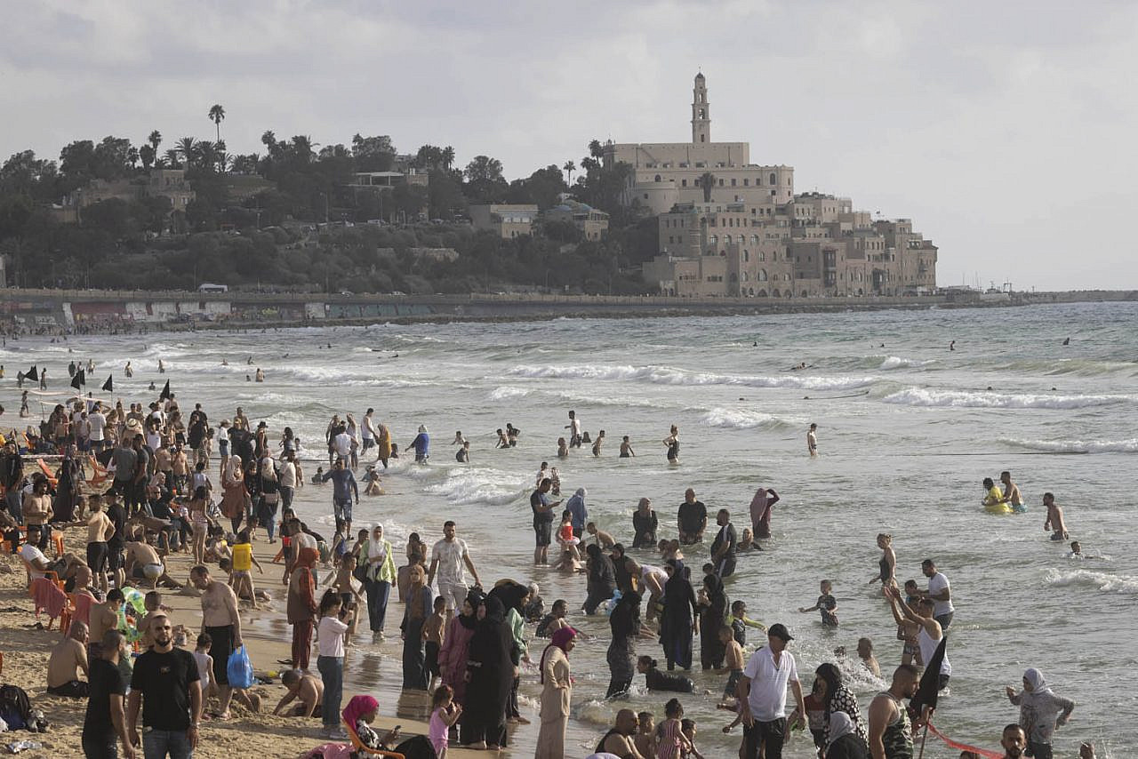 Thousands of Palestinians from the West Bank enjoy the beach in Jaffa during the Eid al-Adha holiday, July 11, 2022. (Oren Ziv)