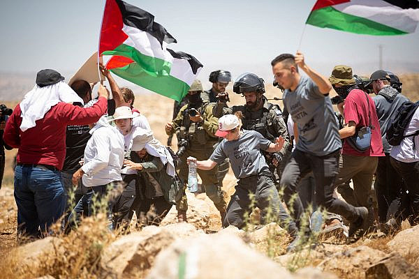 Israeli soldiers push Jewish American activists during a demonstration against the expulsion of Masafer Yatta. (Emily Glick)