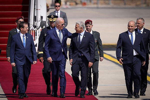 Israeli Prime Minister Yair Lapid greets President Joe Biden at Ben Gurion Airport during the latter's first official visit to Israel as U.S. president, July 13, 2022. (Noam Revkin Fenton/Flash90)