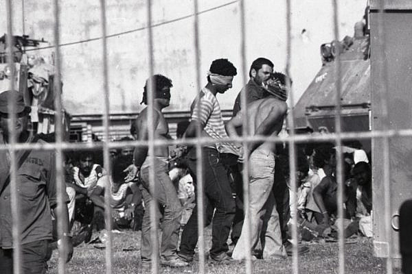 Prisoners inside St. Joseph’s schoolyard during the Israeli army’s invasion and occupation of Sidon, in southern Lebanon, June 1982. (Alain Mingam/Gamma, courtesy of Nurit Kedar)