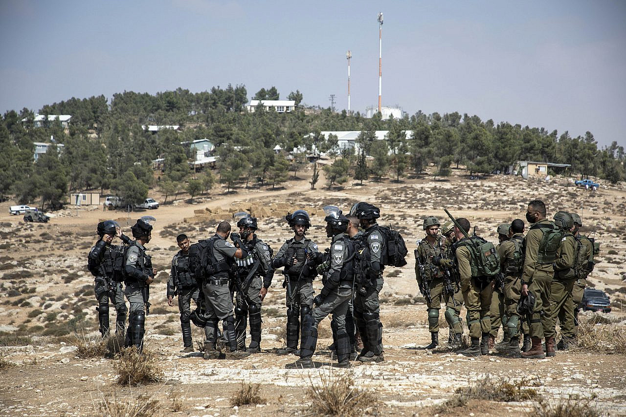 Israeli soldiers and Border Police officers guard the farm outpost of Havat Ma'on, during a solidarity visit and water convoy by left-wing activists to the South Hebron Hills, West Bank, October 2, 2021. (Keren Manor/Activestills.org)