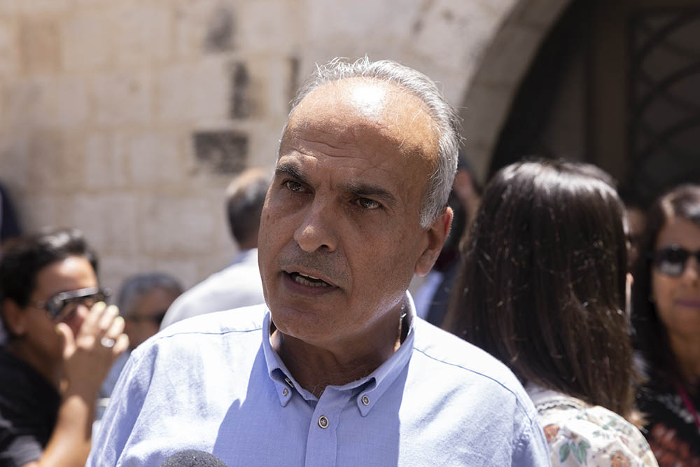 Khaled Quzmar, director of Defense for Children International-Palestine, speaking to the media after the Israeli army's raids on the offices of Palestinian NGOs in Ramallah, West Bank, August 18, 2022. (Oren Ziv)