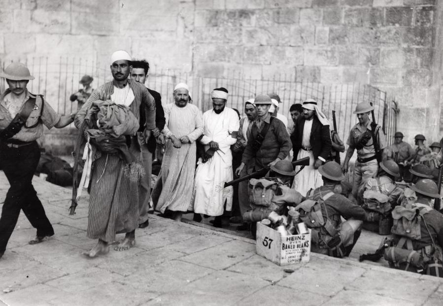 Palestinian Arabs during the Great Revolt against the British Mandate being led out of the Old City of Jerusalem by British soldiers of the English Coldstream Guards, 1938. (Nationaal Archief/Spaarnestad Photo/Het Leven)