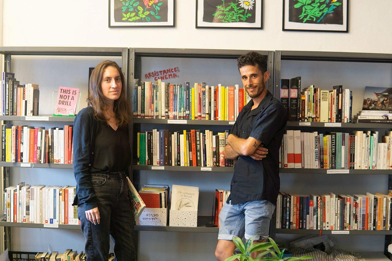 Yuli Gershoni, left, and Ben Ronen, right, who run Culture of Solidarity's radical library. (Alice Austin)
