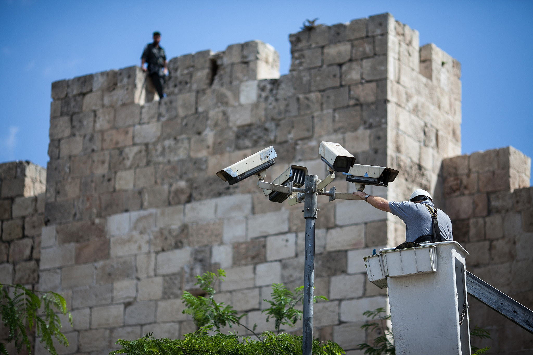 A technician fixes security cameras located near the Old City of Jerusalem, May 20 2012. (Noam Moskowitz/Flash90)