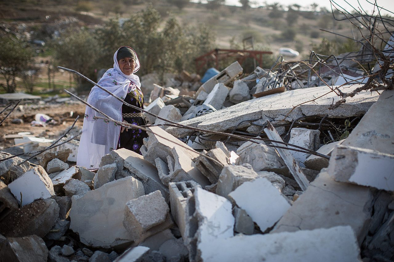 Residents collect their belongings from the ruins of their demolished homes in the Bedouin village of Umm al-Hiran, January 18, 2017. (Hadas Parush/Flash90)