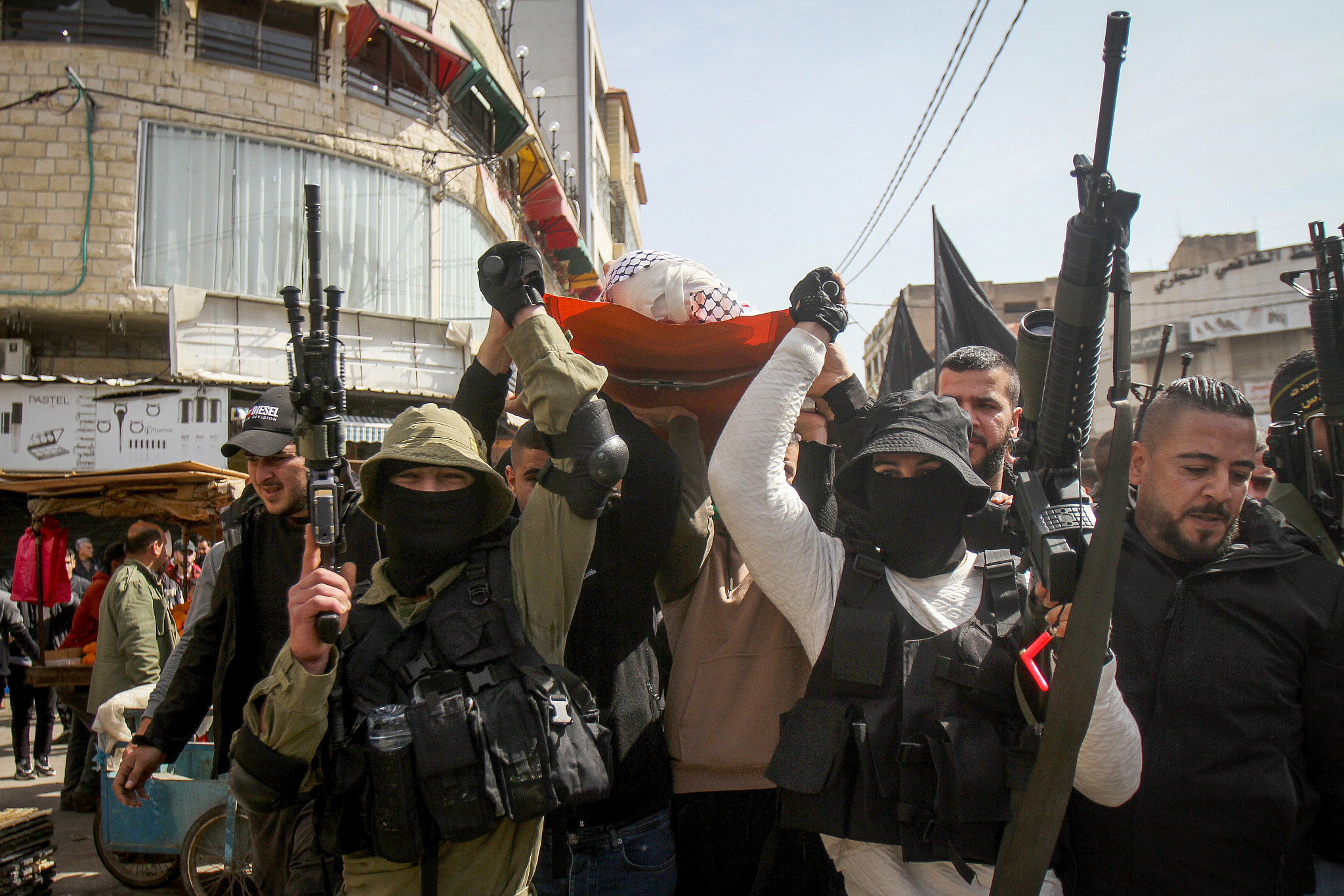Armed Palestinian militants of Islamic Jihad take part in the funeral of two men shot dead by Israeli security forces during their funeral in Jenin, in the West Bank, March 1, 2022. (Nasser Ishtayeh/Flash90)