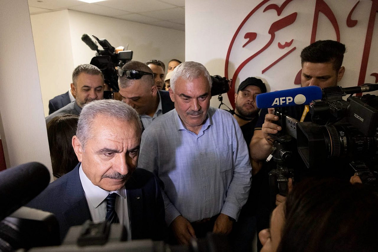 Al-Haq's executive director Shawan Jabarin, next to Palestinian Prime Minister Mohammed Shtayyeh, speaks to the media after the Israeli army raided the offices of several Palestinian NGOs, Ramallah, the West Bank, August 18, 2022. (Oren Ziv)