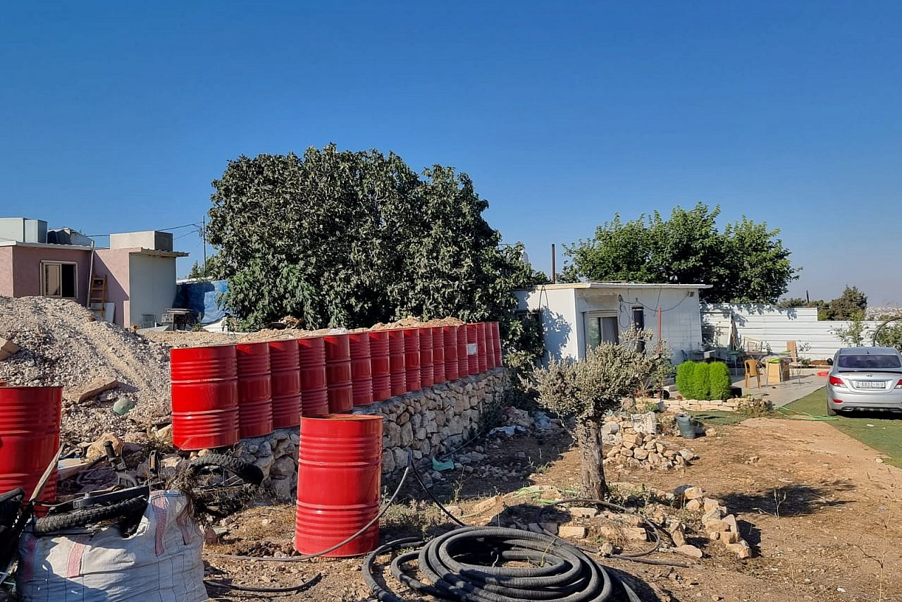A fence made out of barrels so that the Israeli army won't demolish it, An-Nabi Samwil, occupied West Bank, August 1, 2022. (Yuval Abraham)
