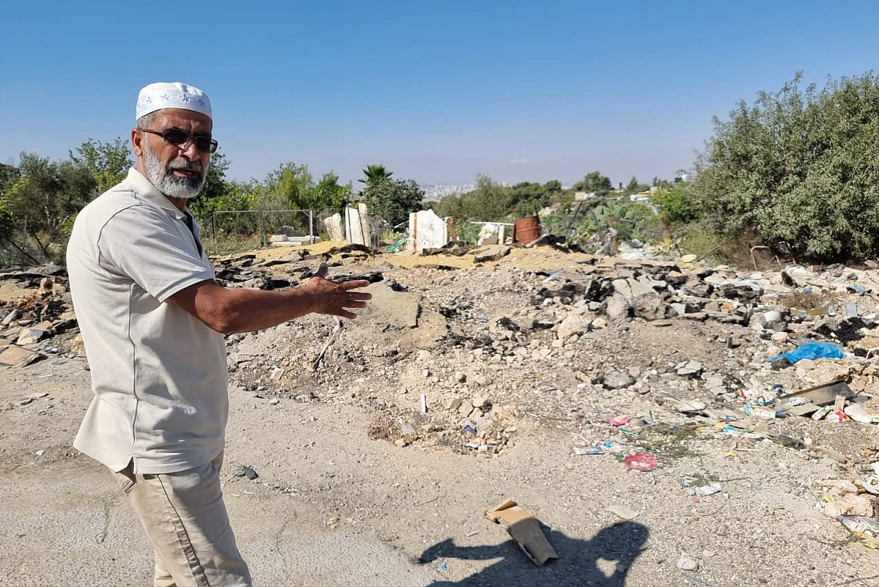 Eid Barakat, an activist and resident of An-Nabi Samwil, points to the remains of a recent demolition carried out by the Israeli Civil Administration, August 1, 2022. (Yuval Abraham)