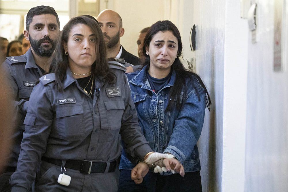 Palestinian journalist Lama Ghosheh is led into a hearing at the Jerusalem Magistrate's Court, accused of identification with a terrorist organization and incitement to violence because of Facebook posts, September 12, 2022. (Oren Ziv)